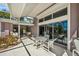 Covered patio with seating area, adjacent to a kitchen and pool at 12440 Placida Rd, Placida, FL 33946