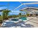 Lush pool and spa area with a screened enclosure at 12440 Placida Rd, Placida, FL 33946