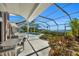 Inviting pool and spa area with a screened enclosure at 12440 Placida Rd, Placida, FL 33946