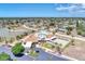 An aerial view shows the community clubhouse, pool, tennis and shuffleboard courts, and a scenic pond at 13525 Dibella Ave, Port Charlotte, FL 33981