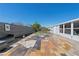 A colorful, brick paver back patio features a lounge area with a metal privacy fence and a well-manicured lawn at 13525 Dibella Ave, Port Charlotte, FL 33981