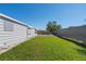 This backyard features a lush green lawn and ample space for outdoor activities at 13525 Dibella Ave, Port Charlotte, FL 33981