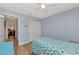 Serene bedroom with light blue walls, featuring wood floors and closet with sliding doors at 13525 Dibella Ave, Port Charlotte, FL 33981