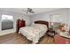 A well-lit bedroom features a decorative ceiling fan, a dresser, and a charming patterned quilt at 13525 Dibella Ave, Port Charlotte, FL 33981