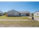 Charming one-story home with blue exterior, well-maintained lawn, and inviting front porch area at 13525 Dibella Ave, Port Charlotte, FL 33981