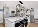 Bright and updated kitchen with stone backsplash, modern appliances, and bar seating at 13525 Dibella Ave, Port Charlotte, FL 33981