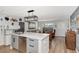 Open kitchen with island seating flows seamlessly into the living room, perfect for entertaining at 13525 Dibella Ave, Port Charlotte, FL 33981