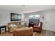 Comfortable living room with light gray walls, neutral sofa, and wicker chairs at 13525 Dibella Ave, Port Charlotte, FL 33981