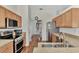 Modern kitchen with stainless steel appliances and wood cabinets at 2341 Rio De Janeiro Ave, Punta Gorda, FL 33983