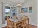 Cozy dining area with wooden table and chairs, and a view to the backyard at 2341 Rio De Janeiro Ave, Punta Gorda, FL 33983