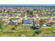 Aerial view of a house with a pool and backyard in a quiet neighborhood at 2341 Rio De Janeiro Ave, Punta Gorda, FL 33983