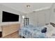 Bright bedroom with a queen bed, dresser, and large TV at 2341 Rio De Janeiro Ave, Punta Gorda, FL 33983