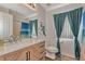 Bathroom with wood vanity, large mirror, and teal shower curtain at 2341 Rio De Janeiro Ave, Punta Gorda, FL 33983