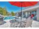 Enjoy dining outdoors by the pool with red umbrella at 2341 Rio De Janeiro Ave, Punta Gorda, FL 33983
