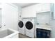 Laundry room with washer, dryer, and ample counter space at 10476 Sherman St, Englewood, FL 34224