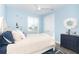 Bright bedroom with a queen bed, light blue walls, and nautical decor at 10476 Sherman St, Englewood, FL 34224