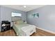Bedroom with a queen-size bed, wood-look floors and window at 13525 Dibella Ave, Port Charlotte, FL 33981