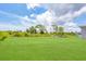 Green grassy backyard with partial view of house at 8343 Olsen St, Port Charlotte, FL 33981