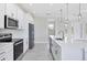 Modern kitchen features stainless steel appliances and white cabinetry at 8343 Olsen St, Port Charlotte, FL 33981