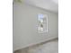 Simple bedroom with a window and grey tile floor at 8343 Olsen St, Port Charlotte, FL 33981