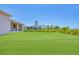 Large backyard with lush green grass and screened enclosure at 8343 Olsen St, Port Charlotte, FL 33981