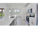 White kitchen with stainless steel appliances and expansive island at 8343 Olsen St, Port Charlotte, FL 33981