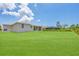 Spacious backyard, view of house and screened enclosure at 8343 Olsen St, Port Charlotte, FL 33981