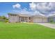 New construction home with a two-car garage and lush lawn at 8343 Olsen St, Port Charlotte, FL 33981