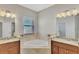 Bathroom boasts dual vanities and a corner soaking tub at 584 Gadsen St, Englewood, FL 34223
