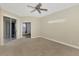 Bedroom with ceiling fan, carpet, and sliding glass doors at 584 Gadsen St, Englewood, FL 34223