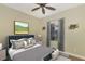 Comfortable bedroom featuring a ceiling fan, large window for natural light, and neutral décor at 584 Gadsen St, Englewood, FL 34223