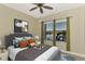 Stylish bedroom with ceiling fan and large windows offering a tranquil view of the water at 584 Gadsen St, Englewood, FL 34223