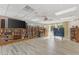 Community room with bookshelves, TV, and game table at 584 Gadsen St, Englewood, FL 34223