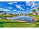 Scenic view of a lake with multiple homes and lush landscaping at 584 Gadsen St, Englewood, FL 34223