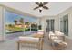 Relaxing screened lanai with comfortable seating, ceiling fan, and picturesque water views at 584 Gadsen St, Englewood, FL 34223