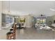 Open-concept living and dining areas, with bar seating, tile flooring, and views of the screened lanai at 584 Gadsen St, Englewood, FL 34223