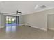 Large living room with tile floors and sliding glass doors at 584 Gadsen St, Englewood, FL 34223