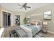 Cozy main bedroom with a ceiling fan, slider door access to the lanai and a dedicated office at 584 Gadsen St, Englewood, FL 34223