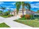 Single story home with attached garage and landscaping at 584 Gadsen St, Englewood, FL 34223