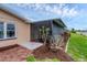 Screened-in porch with a tiled patio and plants at 76 Caddy Rd, Rotonda West, FL 33947