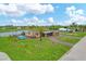 Single story home with a pool and palm tree at 76 Caddy Rd, Rotonda West, FL 33947
