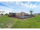 Backyard pool with a black fence and landscaping at 76 Caddy Rd, Rotonda West, FL 33947