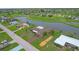 Home near golf course and waterway, aerial view at 76 Caddy Rd, Rotonda West, FL 33947