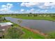Community features a serene lakefront setting with lush landscaping and golf course views at 76 Caddy Rd, Rotonda West, FL 33947