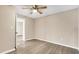 Simple bedroom with ceiling fan and access to another room at 76 Caddy Rd, Rotonda West, FL 33947