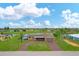 Aerial view of home with pool and golf course views at 76 Caddy Rd, Rotonda West, FL 33947