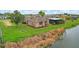 Single story house with canal views and lush landscaping at 76 Caddy Rd, Rotonda West, FL 33947