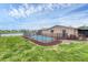 Inviting kidney-shaped pool with a black fence at 76 Caddy Rd, Rotonda West, FL 33947