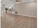 Spacious living room with wood-look flooring and ceiling fan at 76 Caddy Rd, Rotonda West, FL 33947