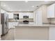 Modern kitchen featuring white shaker cabinets, granite countertops, and stainless steel appliances at 76 Caddy Rd, Rotonda West, FL 33947